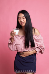 Asian woman drinking a glass of milk got stomachache.