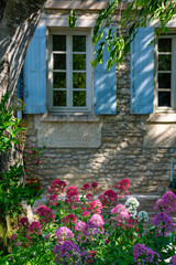 Fototapeta na wymiar Old cosy Provencal house with garden full of flowers