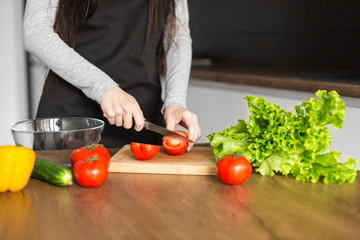 Young trendy woman cooking healthy food in the morning