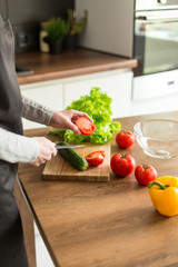 Young trendy woman cooking healthy food in the morning