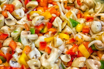 Background of healthy fresh vegetarian salad. colored chopped vegetables. Sliced salad, top view.
