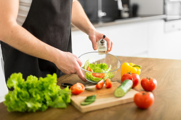 Young trendy man cooking healthy food in the morning