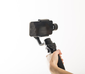 woman hand and gimbal with phone on white background