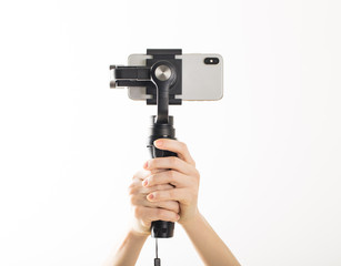 woman hand and gimbal with phone on white background