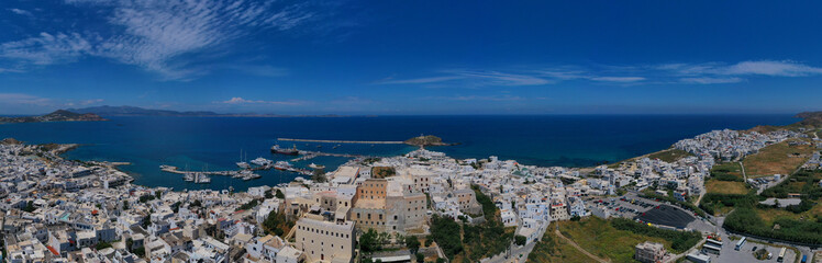 Aerial drone photo of iconic port of Naxos island featuring uphill castle and beautiful Temple of Apollon or Gate, Cyclades, Greece