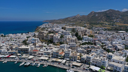 Fototapeta na wymiar Aerial drone photo of iconic chora, main town of Naxos island featuring beautiful uphill castle views to the Aegean deep blue sea and Temple of Apollon at the background, Cyclades, Greece