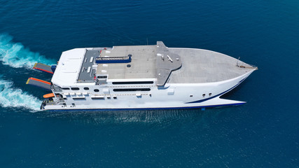 Aerial drone top view photo of high speed passenger ferry arriving at port of Mykonos island,...