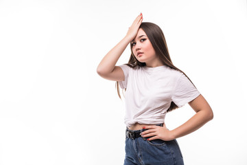 Young asian woman surprised with hand on head for mistake, remember error over isolated background....