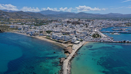 Aerial drone photo of iconic port of Naxos island featuring uphill castle and beautiful Temple of Apollon or Gate, Cyclades, Greece