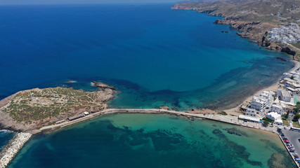 Aerial drone panoramic view of iconic and unique Temple of Apollon or Portara (Gate) with breathtaking views to port - town and castle of Naxos island and the Aegean blue sea, Cyclades, Greece