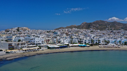 Fototapeta na wymiar Aerial drone panoramic photo of famous turquoise sea sandy beach of Saint George next to chora main town of Naxos island with beautiful uphill castle, Cyclades, Greece