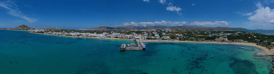 Fototapeta na wymiar Aerial drone photo of breathtaking turquoise round sandy beach and small village and small seaside picturesque chapel of Agia Anna, Naxos island, Cyclades, Greece