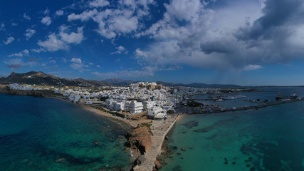 Fototapeta na wymiar Aerial drone photo of iconic chora, main town of Naxos island featuring beautiful uphill castle views to the Aegean deep blue sea and Temple of Apollon at the background, Cyclades, Greece