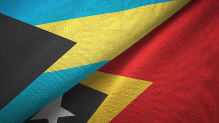 Obraz premium Bahamas and Timor-Leste East Timor two flags textile cloth, fabric texture