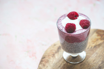 Chia pudding with almond milk, yogurt, pitaya powder and raspberries. Vegan concept.