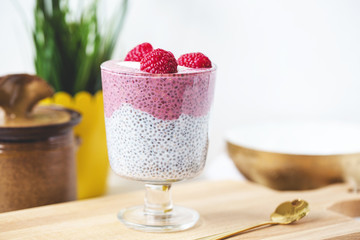 Chia pudding with almond milk, yogurt, pitaya powder and raspberries. Vegan concept.
