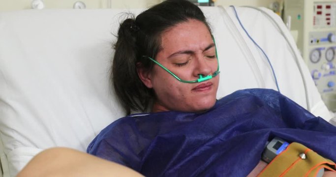 Pregnant woman pushing baby in labor feeling pain