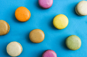 Obraz na płótnie Canvas bright colorful cookies of different colors on blue background