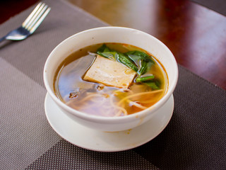 noodle soup plate on the table and napkins with fork