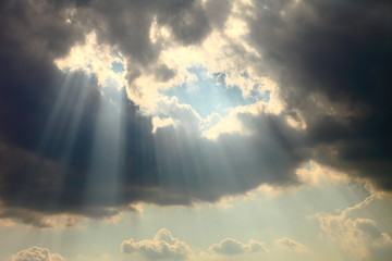 Fototapeta Ray of sun light shine through the gap among cloud for hope and optimism concept obraz