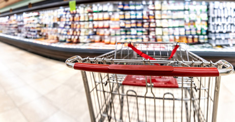 Shopping cart at a supermarket aisle
