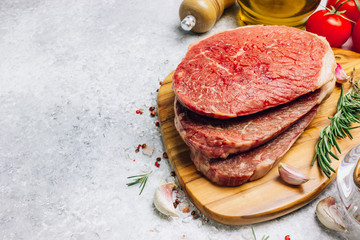 Fresh raw Black Angus beef steak on wooden board