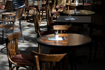 Fototapeta na wymiar empty tables and chairs outside restaurant 