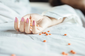 woman suicide on bed taking overdose medicines can be used for slimming pills concep