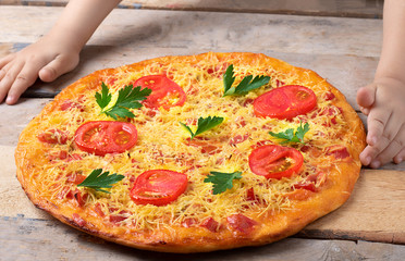 homemade pizza on the table and kids hands, fast food