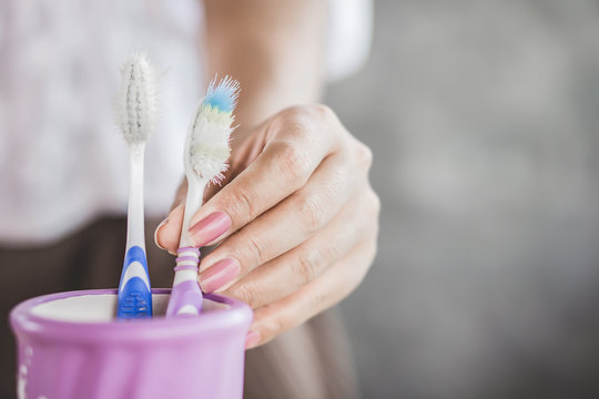 woman hand holding old and destroy toothbrush closeup  
