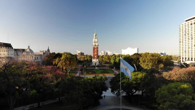 Aerial view of Torre Monumental, in Retiro Neighborhood, with a flag waving during sunset