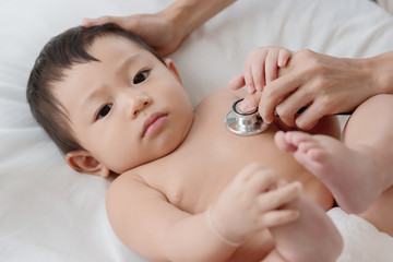 Obraz na płótnie Canvas Pediatrics doctor examining heartbeat and lungs of little baby boy with instruments stethoscope, Health care, Baby, Baby regular health check-up concept