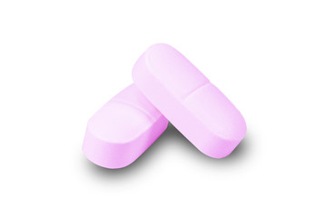 Closeup pink medicine pill isolated on white background.