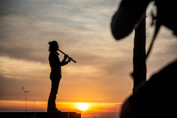 silhouette of a piper
