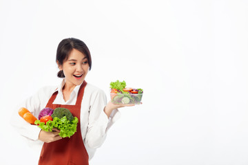 Asian young woman stands to hold vegetables with fresh fruit, Healthy diet. Antioxidant in meal, Risks in food safety, Clean eating food concept with copy space.