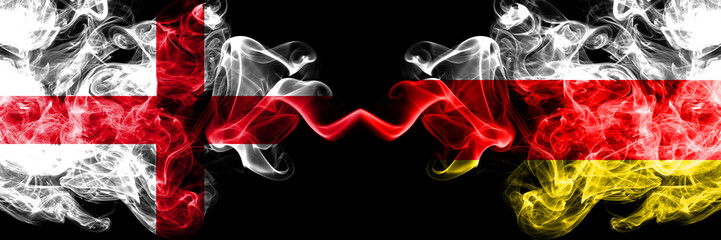 English vs South Ossetia smoky mystic flags placed side by side. Thick colored silky smokes flag of England and South Ossetia.