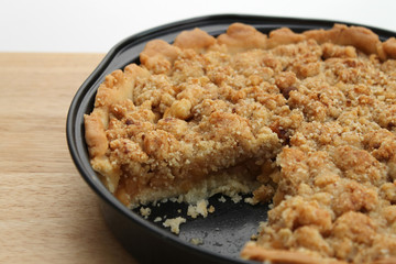 close up of delicious brown apple pie in tray
