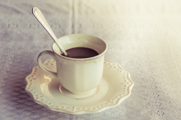 White cup with hot coffee and break time in the morning on a table