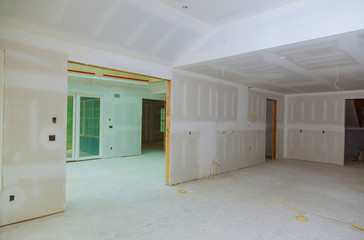 Close up on ceiling construction details with gypsum plaster walls and ceiling of home under construction.