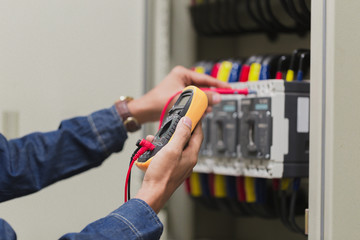 Electrician engineer work  tester measuring  voltage and current of power electric line in...