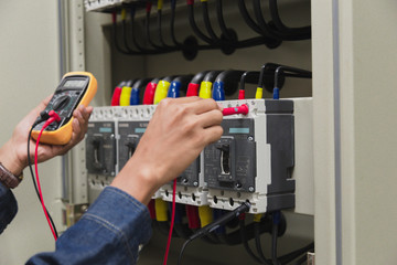 Electrician engineer work  tester measuring  voltage and current of power electric line in...