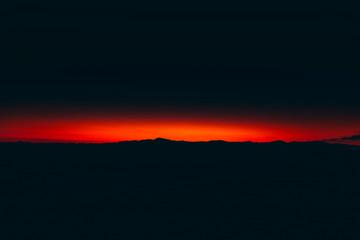 Mountain peaks and clouds at sunrise time