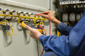 Electrician engineer work  tester measuring  voltage and current of power electric line in...
