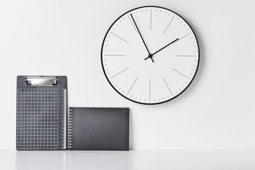Office supplies, sticky and round clock on white