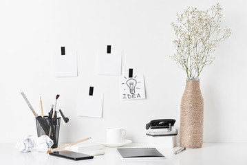 Office supplies and wall clock on white