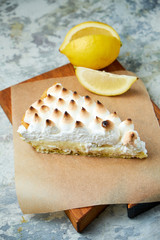 Lemon tart . Gray textured background. Beautiful serving dishes. Dessert. Food chain