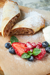Apple strudel. Gray textured background. Beautiful serving dishes. Dessert. Food chain