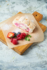 Meringue roll. Gray textured background. Beautiful serving dishes. Dessert. Food chain
