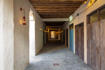 A narrow street in the old town of clay houses.