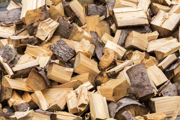 Isolated view on chopped wood. Piled in an unsorted way, looking quite chaotic. Ready to be set on...